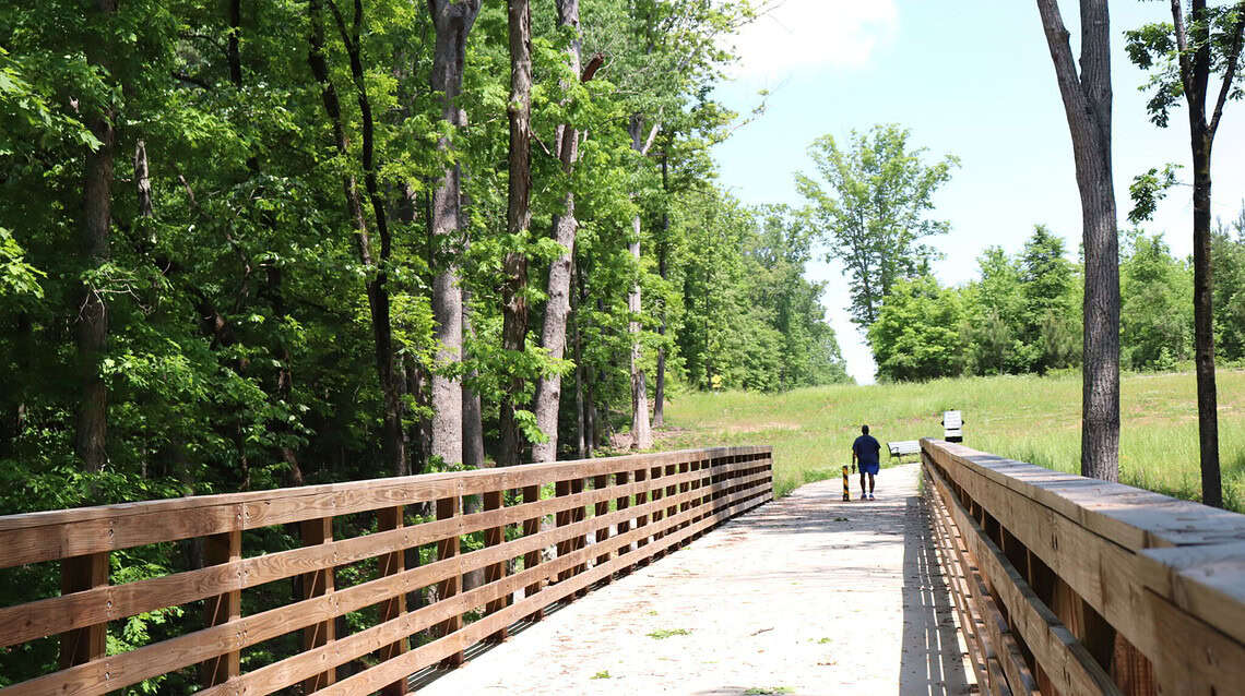 Man hiking on the PATH trail in Henry County in summer.