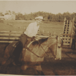 Mr. Vaughters Riding With His Farmhouse in the Background 